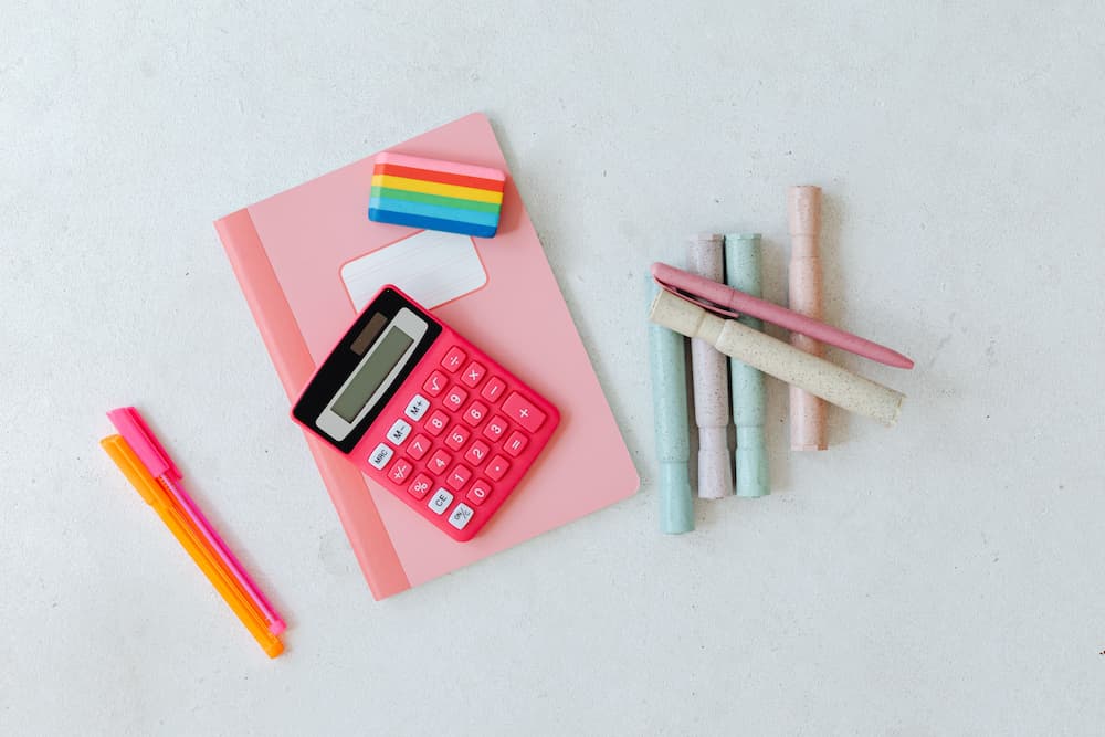 Cuadernos, calculadora y rotuladores escolares preparados sobre un escritorio para las clases en Málaga.